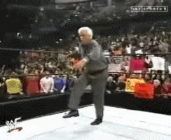 Man in Suit Dancing in Wrestling Ring