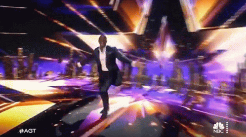 Man in Suit Dancing on NBC Stage
