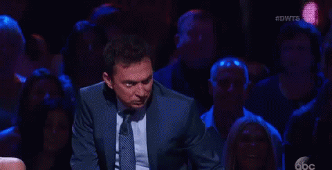 Man in Suit Dancing on Stage