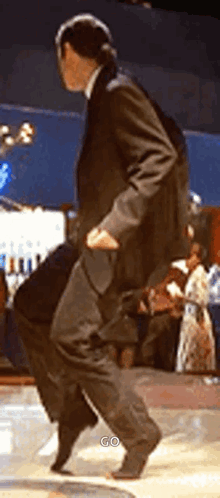 Man in Suit Dancing on Stage