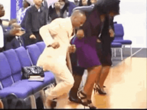 Man in Suit Dancing With Purple-Dressed Woman