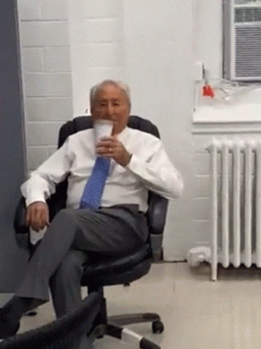 Man in Suit Drinking Coffee