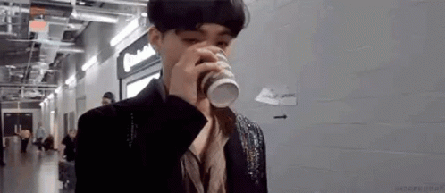 Man in Suit Drinking Coffee