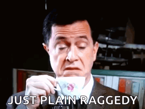 Man in Suit Drinking Cup Saying Just Plain Raggedy
