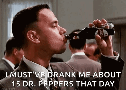 Man in Suit Drinking Dr Pepper