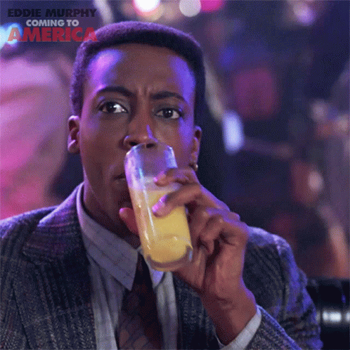 Man in Suit Drinking From NBA Mug