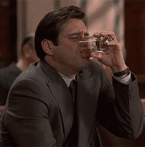 Man in Suit Drinking Glass