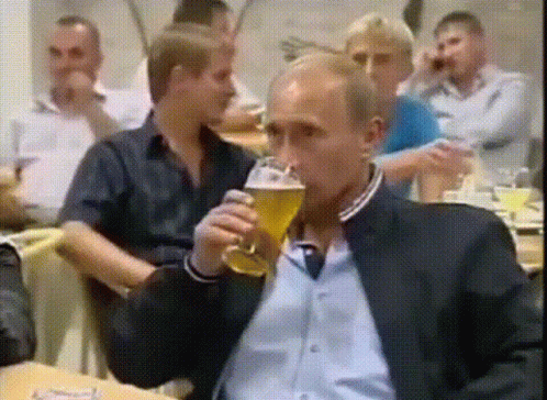 Man in Suit Drinking Glass of Beer