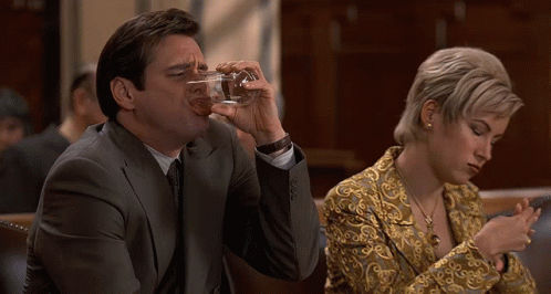 Man in Suit Drinking Glass Woman on Phone