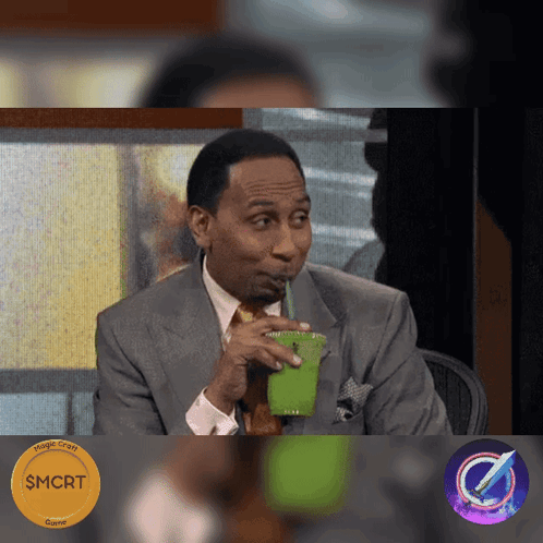 Man in Suit Drinking Green Cup Through Straw