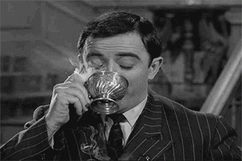 Man In Suit Drinking Silver Cup GIF