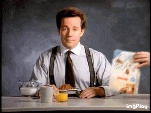 Man In Suit Eating Cereal And Drinking Orange Juice GIF