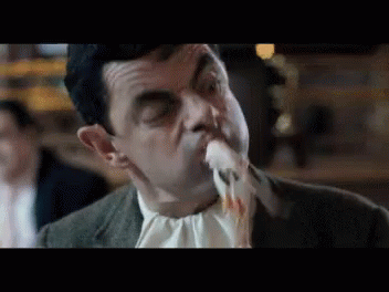 Man in Suit Eating Food