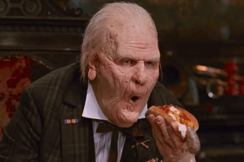 Man in Suit Eating Hot Dog with Ketchup and Mustard