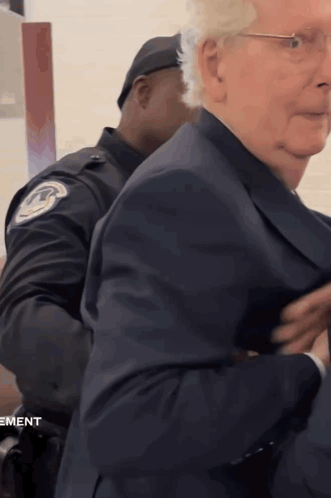 Man In Suit Escorted By Police Officer Movement