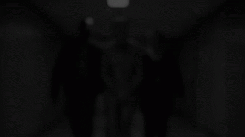 Man in Suit Escorted by Two Police Officers
