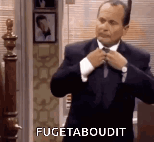 Man in Suit Fixing Tie Saying Fugetaboudit