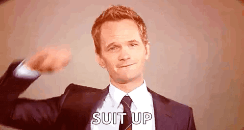 Man in Suit Flexing Muscles Says Suit Up