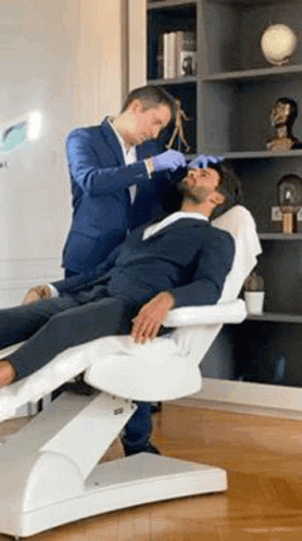 Man in Suit Getting Facial Treatment