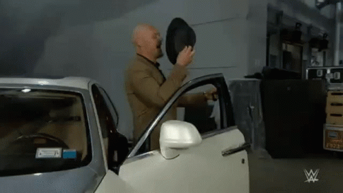 Man in Suit Getting Out Car with Top Hat