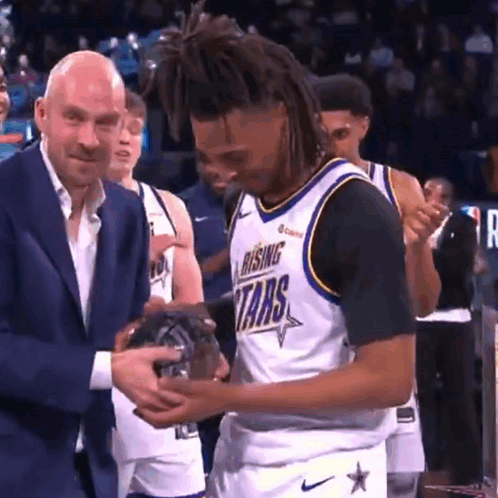 Man in Suit Giving Rising Stars Jersey