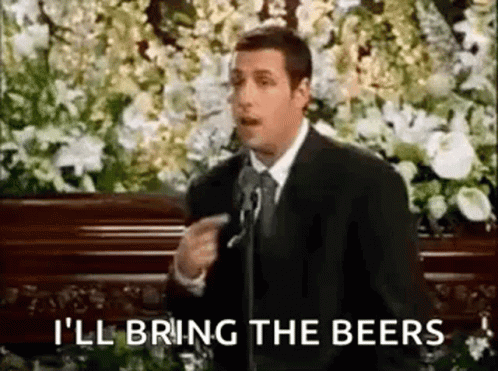 Man in Suit Giving Speech at Funeral Pointing at Camera