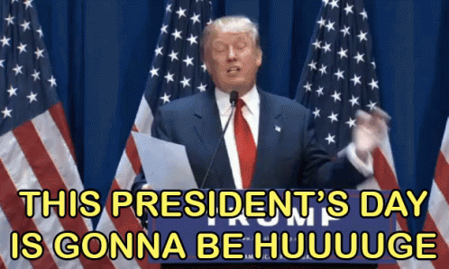 Man in Suit Giving Speech in Front of American Flags