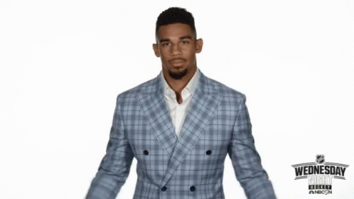 Man in Suit Giving Thumbs Down