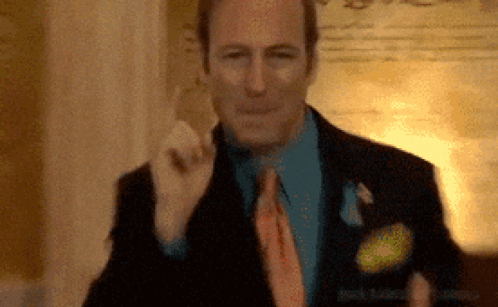Man in Suit Giving Thumbs Up