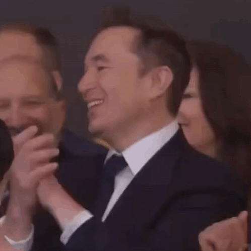 Man in Suit Giving Thumbs Up