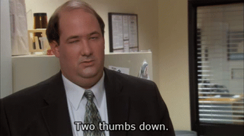 Man in Suit Giving Two Thumbs Down