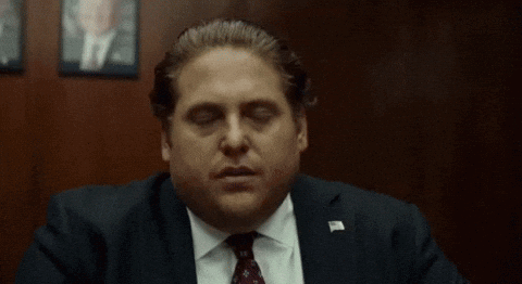 Man in Suit Hand on Face Eyes Closed