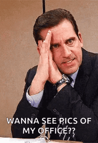 Man In Suit Hands On Face At Desk GIF