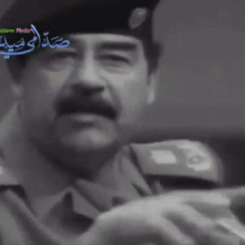 Man in Suit Hat Holding Sword Arabic News
