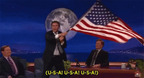 Man In Suit Holding American Flag Saying USAI USAI GIF