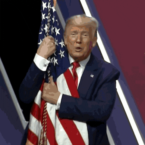Man in Suit Holding American Flag