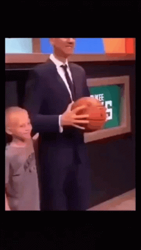 Man In Suit Holding Basketball Next To Child GIF