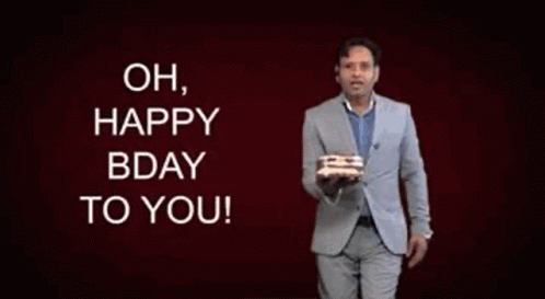 Man in Suit Holding Birthday Cake Saying Oh Happy Bday to You