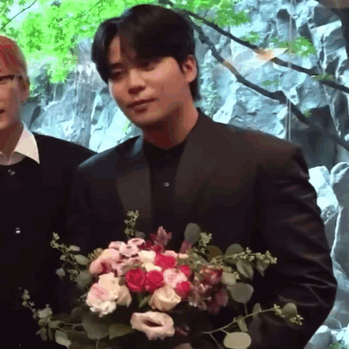 Man in Suit Holding Bouquet