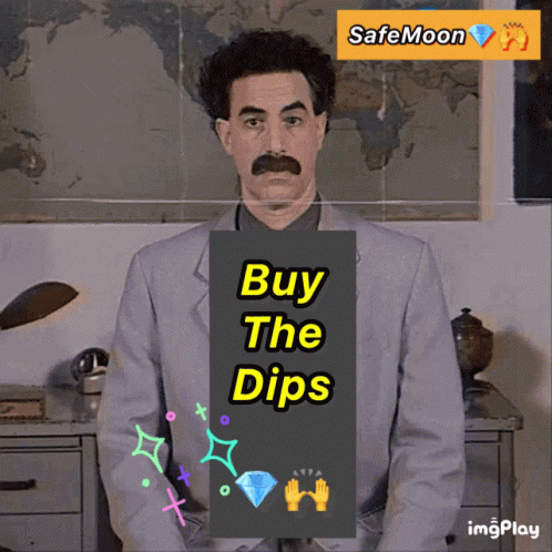 Man in Suit Holding Buy the Dips Sign