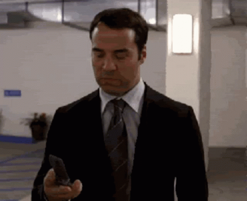 Man in Suit Holding Cell Phone