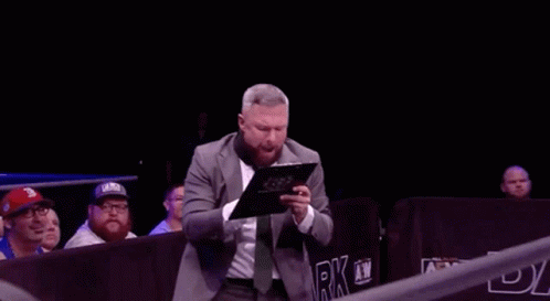 Man in Suit Holding Clipboard