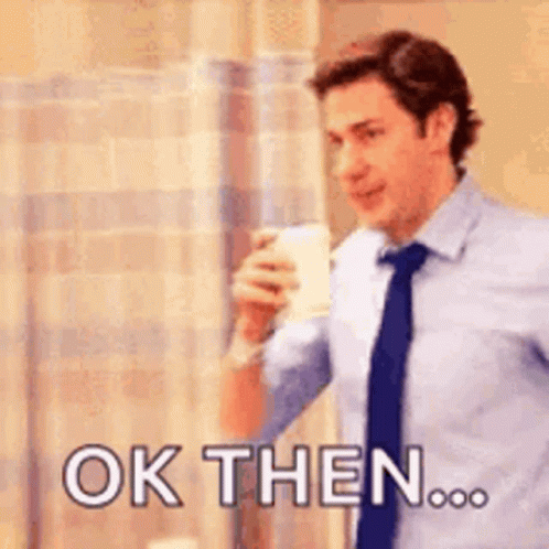 Man in Suit Holding Coffee Saying Ok Then