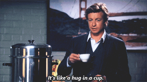 Man in Suit Holding Coffee Says It's Like a Hug in a Cup