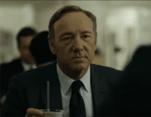 Man in Suit Holding Cup With Straw