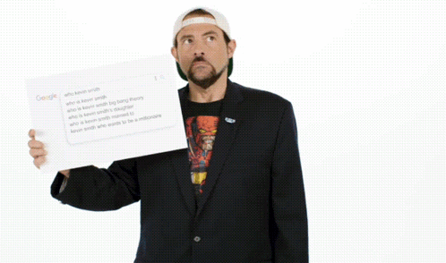 Man in Suit Holding Did I Win Paper