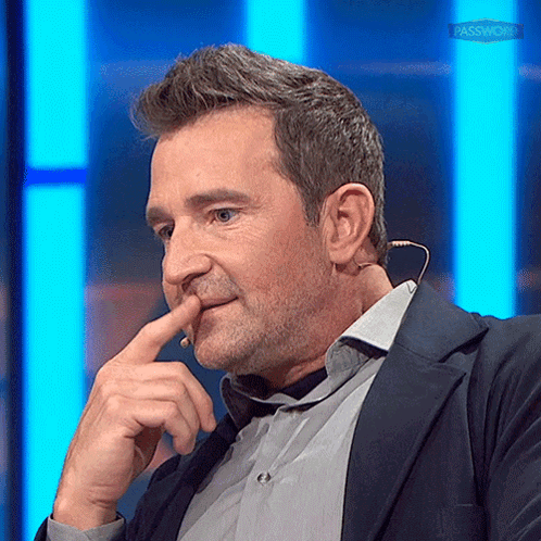 Man In Suit Holding Finger To Nose GIF