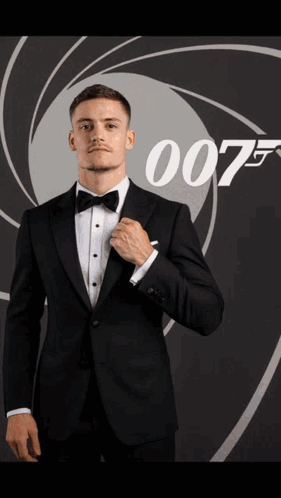 Man in Suit Holding Fireball in Front of 007 Poster