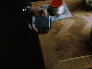 Man in Suit Holding Flip Phone Saying Found It