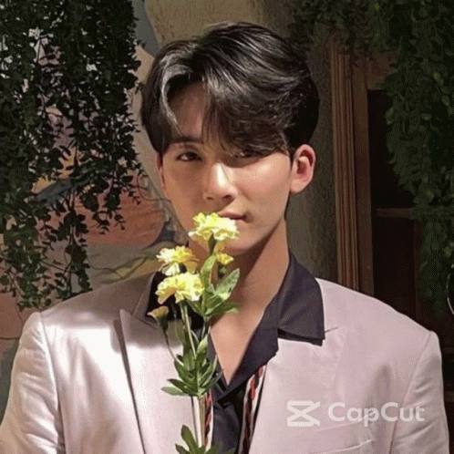Man in Suit Holding Flower in Mouth Cap Cut